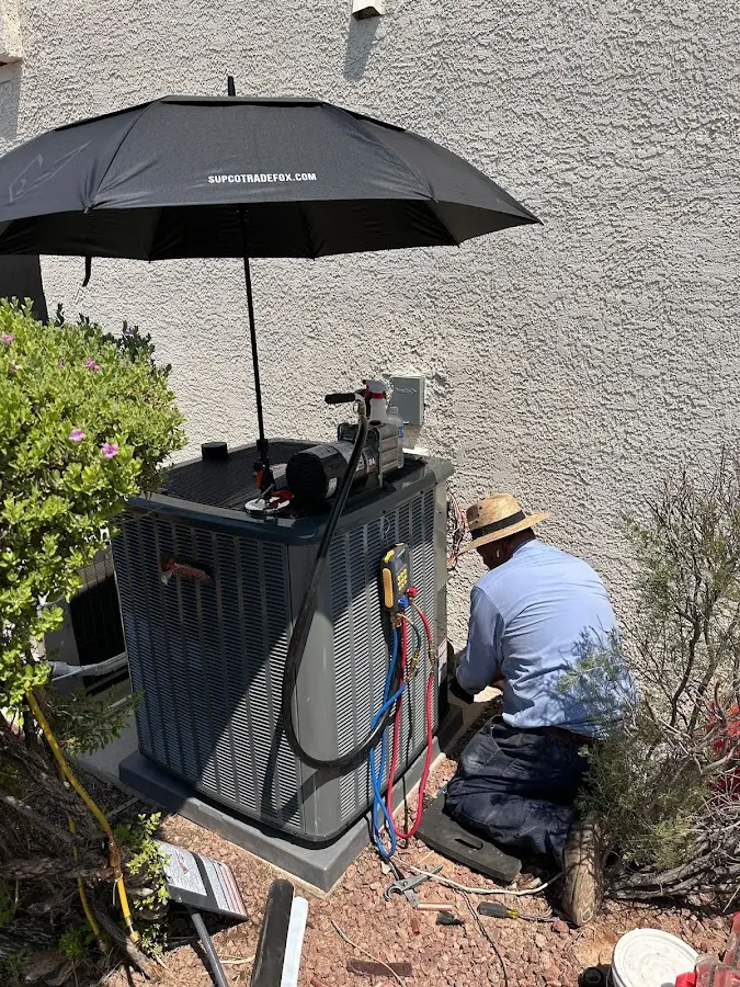 HVAC technician performing outdoor AC maintenance in Venice