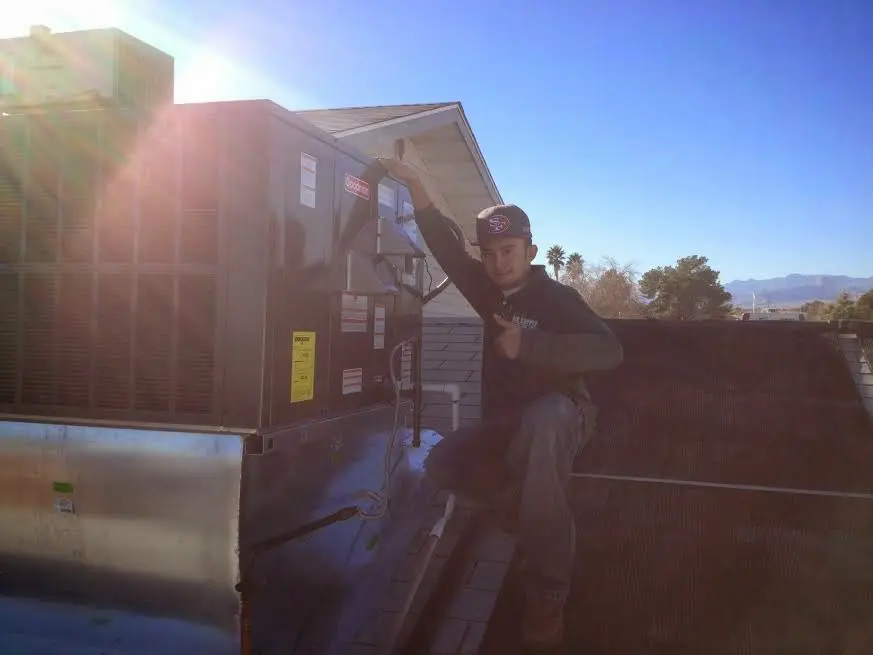 HVAC technician performing HVAC Inspection on a rooftop unit in Venice